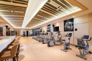 a gym with a row of exercise bikes and treadmills at Empark Hotel Fuzhou Exhibition Centre in Fuzhou