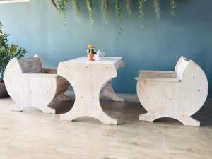 a bench and table in a room with a wall at Zleepingpills Aonang Krabi in Krabi