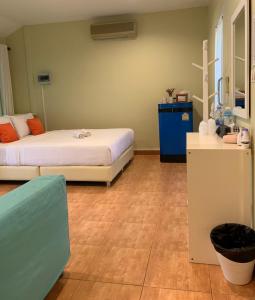 a room with two beds and a blue cabinet at Khao Yai Cottage in Mu Si