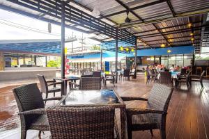 a restaurant with chairs and tables and a table and tablesktop at Naiyang Beach Hotel SHA Plus in Nai Yang Beach