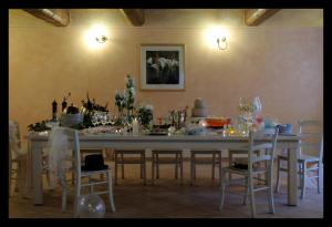 a dining room with a table with chairs and wine glasses at Locanda Della Fiorina in San Felice sul Panaro