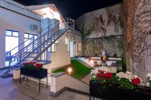 a building with a staircase and flowers in a courtyard at Central Park Residence in Belgrade