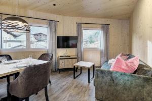 a living room with a couch and a table at Herbst Wohnerlebnis in Lofer