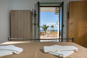 a bedroom with a bed with a view of the ocean at Pachia Ammos Falasarna in Falasarna
