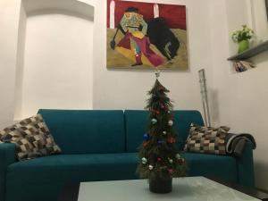 a living room with a blue couch and a christmas tree at City Center AP 2 in Košice