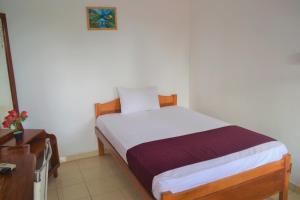 Una cama o camas en una habitación de Gnaanams Hotel and Restaurant