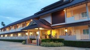 a large building with a lot of windows at Chiangkham Grand Villa - SHA Certified in Chiang Kham