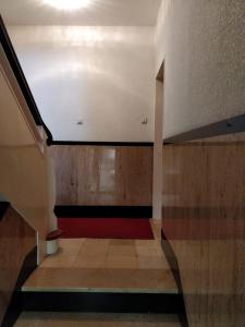 an empty room with a staircase with a red carpet at Einzel-Apartment Düsseldorf Oberkassel in Düsseldorf