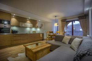 a living room with a couch and a table at Apartament Montagne in Zakopane