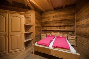 a bedroom with a bed in a wooden room at Glinzhof Mountain Natur Resort Agriturismo in San Candido