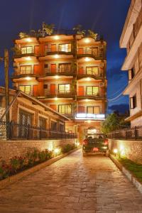 un'auto parcheggiata di fronte a un edificio di notte di Hotel Crystal Palace a Pokhara