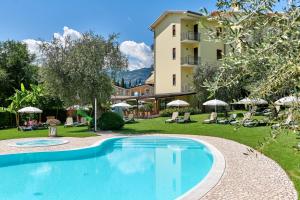 a large swimming pool in front of a building at Eco Hotel Benacus in Malcesine