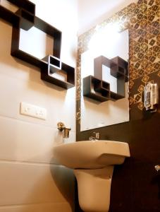 a bathroom with a sink and a mirror at Marari Greenland Homestay in Mararikulam +128 photos