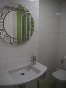 a bathroom with a sink and a mirror and a toilet at Apartamento El Ayuntamiento de Logroño in Logroño