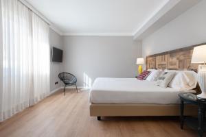 Postel nebo postele na pokoji v ubytování Hotel Leon d'Oro
