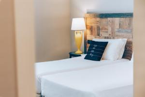 Postel nebo postele na pokoji v ubytování Hotel Leon d'Oro
