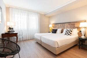 Postel nebo postele na pokoji v ubytování Hotel Leon d'Oro