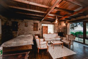 a bedroom with a bed and a couch and chairs at Kirkinca Hotel in Selçuk