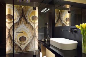 a bathroom with a sink and a shower with a mirror at Lifestyle Suites Rome in Rome