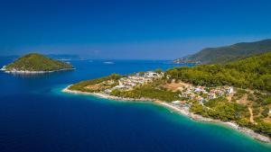 an island in the water with a resort at Adrina Beach Hotel in Panormos Skopelos