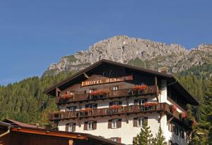 a hotel building with flowers on the balcony at Wellness Hotel Bladen in Sappada