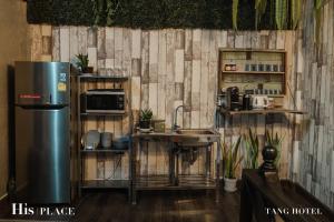 a kitchen with a refrigerator and a sink at Tang House in Bangkok