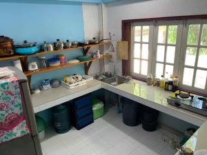 a kitchen with a sink and a counter top at Sano Houes บ้านโสน in Sukhothai