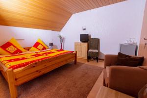 a bedroom with a large wooden bed and a couch at Moselhaus in Zeltingen-Rachtig