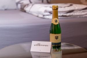 a bottle of wine sitting on a table with a card at Moselhaus in Zeltingen-Rachtig