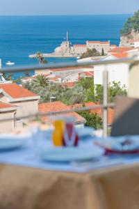 a table with a view of the ocean from a balcony at Hotel WGrand in Petrovac na Moru
