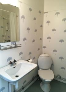 a bathroom with black umbrellas on the wall at Ronneby Havscamping in Listerby