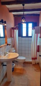 a bathroom with a toilet and a sink at Alojamiento Rural ERMITA SAN JULIAN in Burunchel