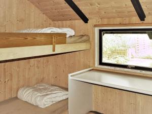 a room with two bunk beds and a window at 8 person holiday home in V ggerl se in Marielyst