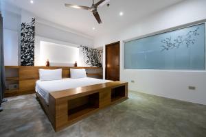 a bedroom with a bed and a large screen at Capital O 468 Element Boutique Hotel in Manila