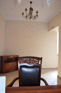 a dining room table with a chair and a chandelier at Kremlevskaya Hotel in Murom