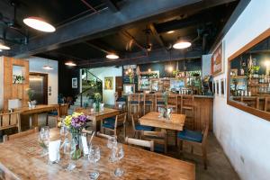 a restaurant with wooden tables and chairs and a bar at Capital O 468 Element Boutique Hotel in Manila