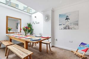a dining room with a wooden table and chairs at Brighton's Best Big House 1 - By My Getaways in Brighton & Hove