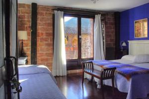 A bed or beds in a room at La Casona del Pastor