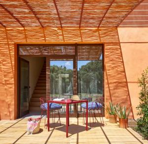a patio with a table and chairs on a deck at Trafalgar Polo Club in El Palmar