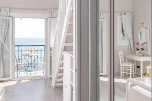 a white room with a view of the ocean at Adrina Beach Hotel in Panormos Skopelos