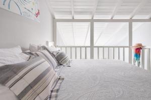 a bedroom with a bed and a window at Adrina Beach Hotel in Panormos Skopelos