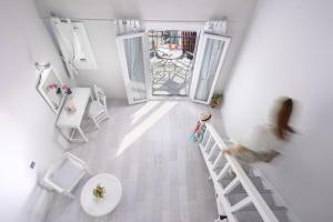 a woman walking up a ladder in a bathroom at Adrina Beach Hotel in Panormos Skopelos
