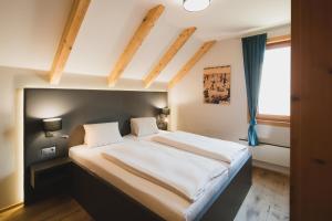 a bedroom with a large bed in a room at MarktlAlm Turracher Höhe in Turracher Hohe