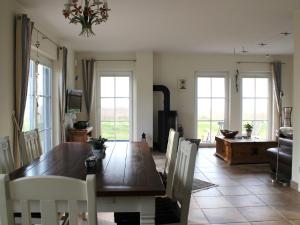a dining room with a wooden table and chairs at Reetdachhaus Windsbraut in Breege
