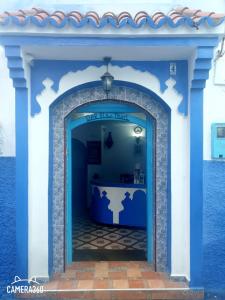 ein blau-weißes Gebäude mit einem Tisch in der Unterkunft Dar Bleu Pearl in Chefchaouen