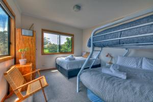 A bed or beds in a room at Dove on Freycinet
