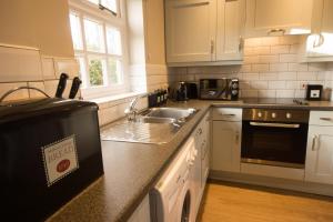 a kitchen with a sink and a counter top at Eyam Cottage - Darwin Lake Holiday Village in Matlock