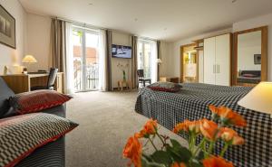 Postel nebo postele na pokoji v ubytování Dom Hotel