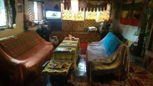 a living room with a couch and a table at Green Zion Garden in Butre