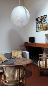 a living room with a couch and a table at Réf 259, Seignosse océan, Villa Patio au calme, plage et commerces à proximité, 6 personnes in Seignosse